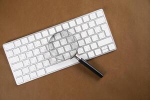magnifier on the computer keyboard. photo
