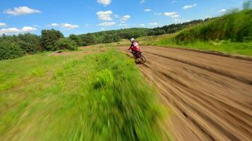 Dynamic FPV shot of a racer on a motocross bike on a track at high speed video