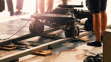 Camera trolley or camera dolly cart rails for filmmaking on studio shooting set. Pro videographer dolly rail track for filming movie mounted on studio floor. Film production dolly and crews in sets photo