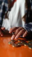 Counting Coins Using Hands on Vibrant Orange Background for a Vivid Visual Experience video