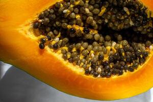 Top view of papaya fruit cut in half with grains. photo