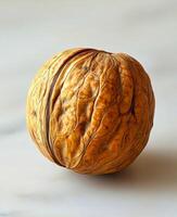 Unique walnut showcasing intricate texture and natural patterns on a marble surface photo