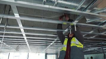 Installation of a ceiling on construction. Renovation in the middle of the house. Creation of a skeleton of networks from metal designs video