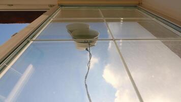 A robot that washes windows. The rays of the morning sun shine into the room. Silhouette of a robot that washes windows video