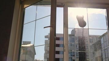 A robot that washes windows. The rays of the morning sun shine into the room. Silhouette of a robot that washes windows video