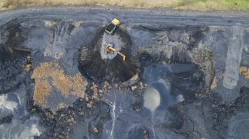 Aerial view on top Excavator loads the car with coal. Black coal that is loaded into the car. video
