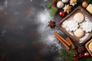 Christmas baking background showing cookies, cinnamon sticks, berries, and star anise on dark rustic table photo