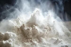White flour creating a mountain landscape with vapor on a dark background photo