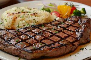 Grilled steak with mashed potatoes and vegetables displaying culinary delights photo