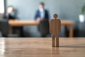 Wooden mannequin stands on table representing candidate during job interview photo
