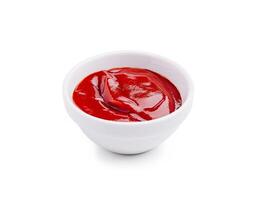 Fresh red ketchup in a white bowl ready for serving at a casual meal setting photo
