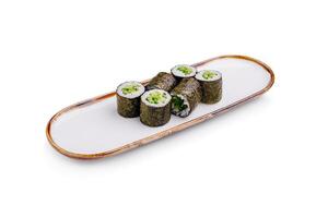 Sushi rolls arranged neatly on a rectangular plate with a minimalistic design in a bright setting photo