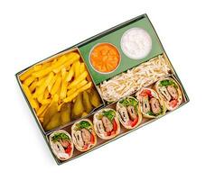 Delicious wrapped sandwiches with fries and sides in a takeout box from a local eatery photo
