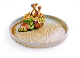 Deliciously plated chicken drumsticks with crunchy coating and refreshing cucumber salad on a rustic dish photo