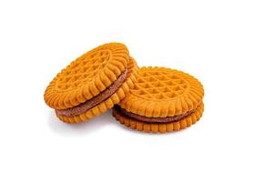 Cookies stacked on a white surface with a textured design and chocolate filling visible between them photo