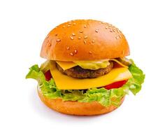 Delicious cheeseburger with fresh lettuce, tomatoes, and pickles served on a sesame seed bun photo