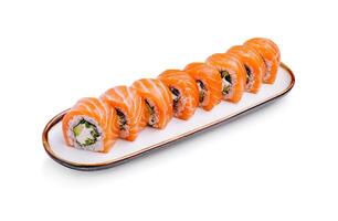 Delicious salmon sushi rolls arranged elegantly on a long serving plate photo