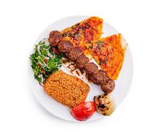 Grilled kebabs served with spicy flatbread, rice, and fresh salad on a plate in a vibrant setting photo