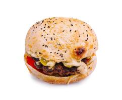 Juicy hamburger with fresh toppings on a sesame seed bun in bright lighting photo
