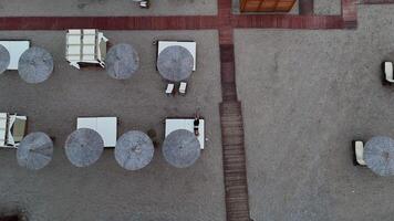 Drone Approaching Girl Relaxing on Beach from Above with Scenic Coastal View video