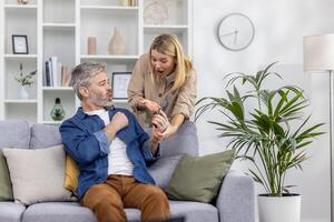 Woman and man having an intense conversation after seeing a message on a smartphone while sitting on a couch. photo