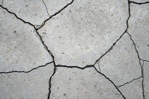Cracked concrete surface material urban environment close-up view structural integrity texture analysis photo