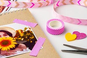 Creating a vibrant scrapbook page with colorful washi tape and embellishments in a bright, cheerful setting photo