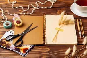 Creative workspace with scrapbook materials and decorative elements during the day photo