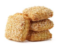Crispy sesame seed cookies stacked together on a plain background for a delightful snack experience photo
