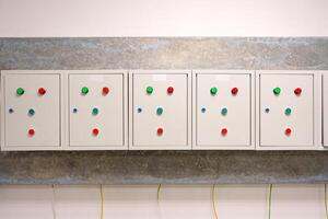 Control panel with indicator lights and buttons in a modern industrial setting photo