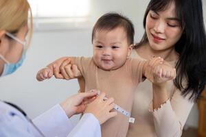 Measuring baby height during a joyful pediatric checkup photo