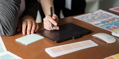 Collaborative graphic design process with digital tools and color swatches photo