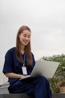 Nurse taking a break while using a laptop for patient care and documentation photo