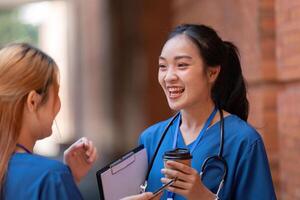 Doctors enjoying a break, smiling and conversing with coffee. photo
