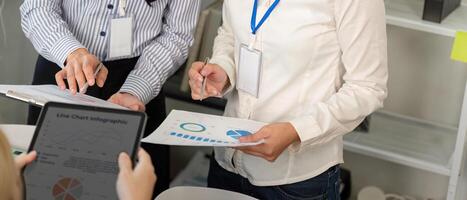 Diverse business team analyzing charts and data in a collaborative meeting. photo