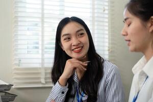 Diverse business team members engaged in a friendly conversation at work. photo