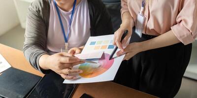 Collaborative graphic design team reviewing color palettes and concepts in a modern studio photo