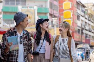 Group of young Asian friends laughing and enjoying each other company while exploring a vibrant market, highlighting travel and friendship. photo
