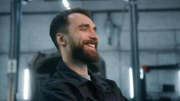 Smiling male guy workman mechanic happy smile profile portrait Caucasian man technician master auto engineer industrial worker crossed hands posing in front of automobile repairing car service concept photo