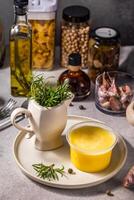Ghee butter, rosemary and various ingredients creating a flavorful culinary scene photo