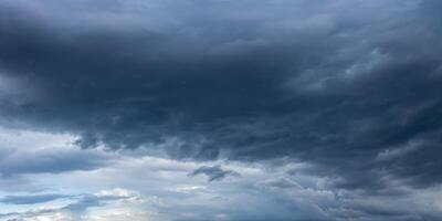 Dark storm clouds gathering in the sky, creating ominous atmosphere photo