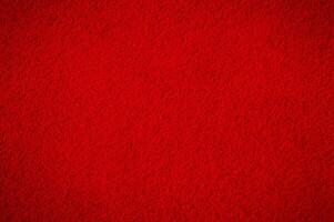 Red suede with darkening along the edge. Suede macro as a background. photo