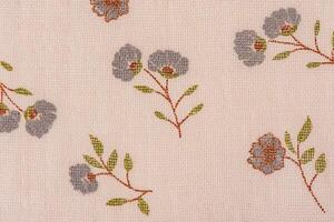 Light beige fabric in a flower as a background macro photo