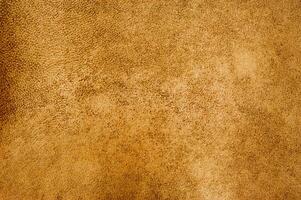 Light brown color suede background. Mustard color, suede leather macro photo, material for designer photo