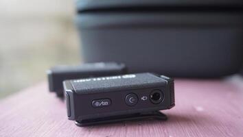 two small transmiter wireless micro phone sitting on top of a table photo