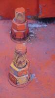 a close up of two orange bolts photo