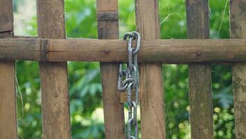 a wooden fence with a chain attached to it photo