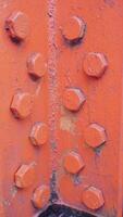 orange steel structure with rivets and bolts photo