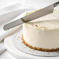 A cake slicer with a serrated edge for clean cuts photo
