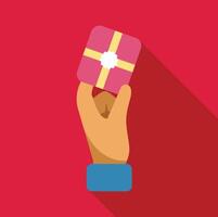 Hand holding a gift box with golden ribbon and label on red background vector